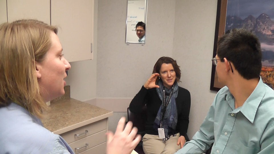 Dr. Liz Banowetz, left, and care coordinator, Sarah Bryson, discuss medication with patient, Roger Mondragon.